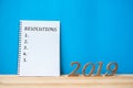 2019 Happy New years with notebook Ã¢â¬ÅResolutions Ã¢â¬Å text and wooden number on table and copy space Royalty Free Stock Photo